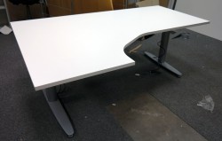 Skrivebord med elektrisk hevsenk i hvitt fra Kinnarps, 180x120cm, ventresløsning, pent brukt understell med ny plate